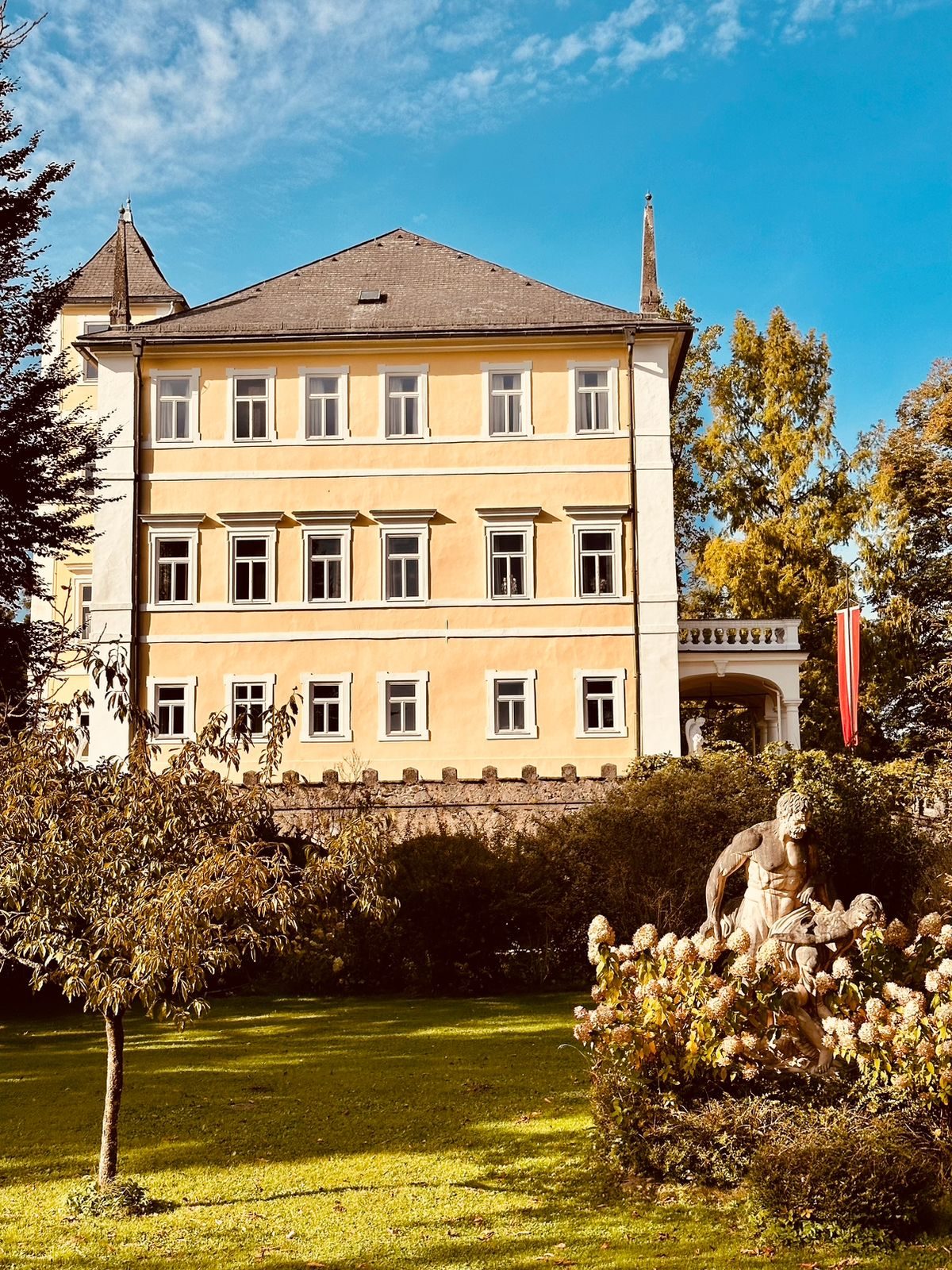 Yellow ancillary historic building with mansard roof