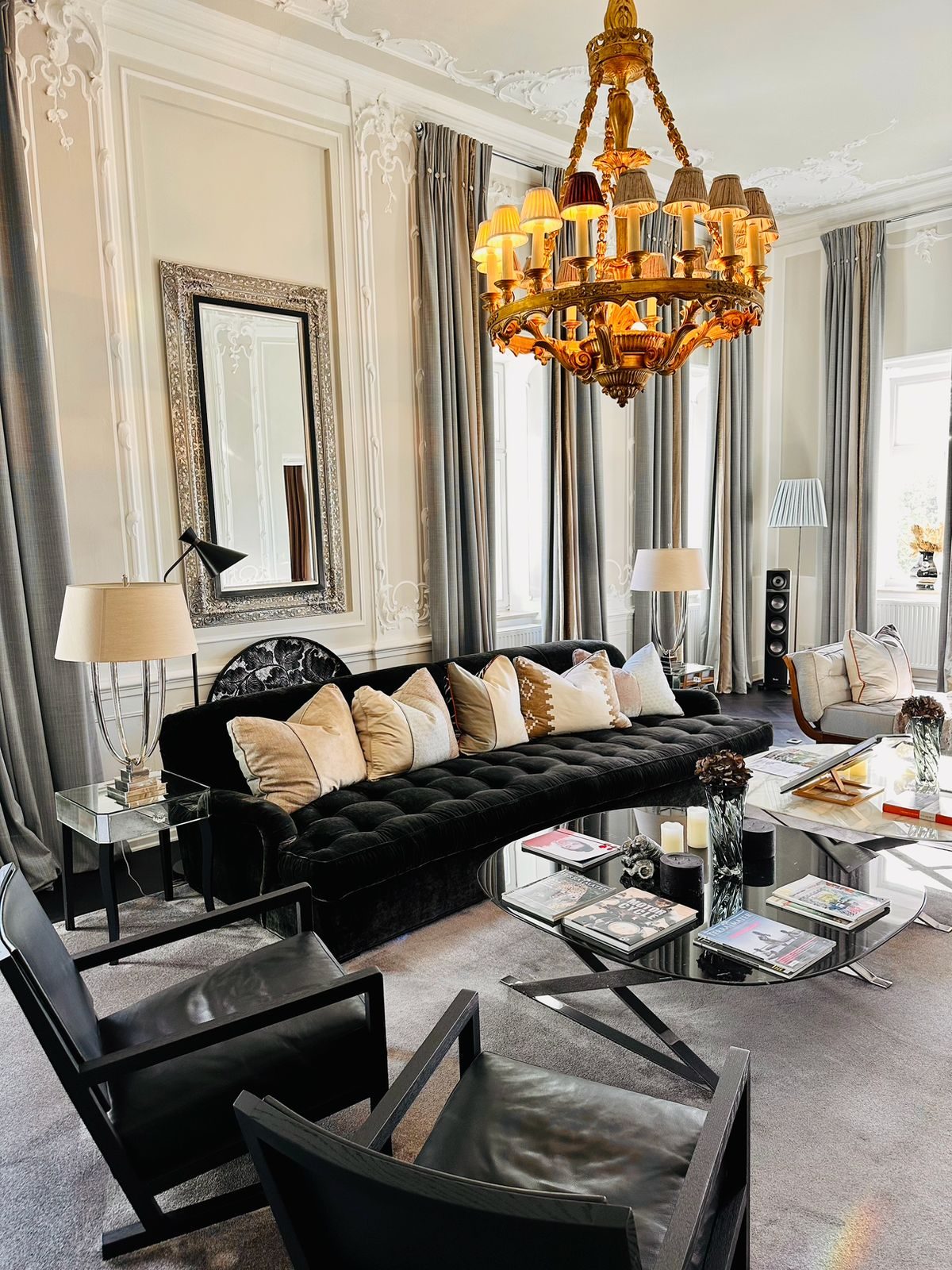 Salon in the Marienheim with dark sofas and chandelier